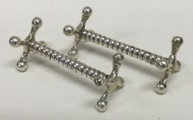 A pair of heavy silver knife rests. Sheffield. Approx. 102 grams. Est £60 - £80.