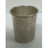 A silver shot cup inscribed, ‘Just a Thimbleful’. Approx. 28 grams. Est. £80 - £120.