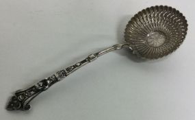 A French silver sifter spoon with figural terminal. Approx. 67 grams. Est. £80 - £120.