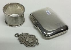 A silver cigarette case together with a napkin ring etc. Approx. 92 grams. Est. £30 - £40.