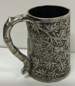 A rare 19th Century Chinese silver mug embossed with leaves and beetles. Approx. 205 grams. Est. £80