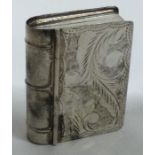 A heavy silver box in the form of a book with engraved decoration. Approx. 21 grams.