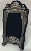 A large decorative silver picture frame. Marked Sterling. Est. £60 - £80.
