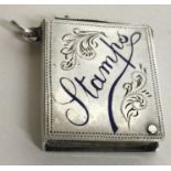 A novelty silver and enamelled stamp case with sliding mechanism. Birmingham 19011.