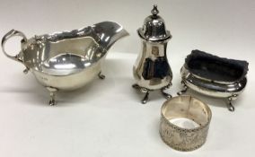 A silver sauce boat together with a napkin ring etc. Approx. 198 grams.