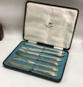 A boxed set of six silver plated tea knives. Est £10 - £20.