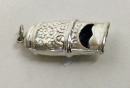 A chased novelty silver whistle. Approx. grams. Est. £20 - £30.