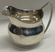 A Georgian silver cream jug with reeded decoration. London. Approx. 104 grams.