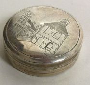 A heavy silver and silver gilt box with lift-off lid engraved with town scene. London 1978.