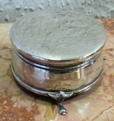 A circular silver ring box with hinged lid. London
