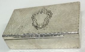 A silver snuff box of hammered design. London 1899. By Goldsmiths and Silversmiths.