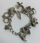 A heavy silver charm bracelet. Approx. 29 grams. Est. £30 - £50.