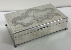 An early 20th Century Chinese silver hinged box engraved with dragons. Marked to base. Approx. 582 g