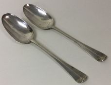 A pair of George II silver shell back spoons. London 1737. By SH. Approx. 81 grams.
