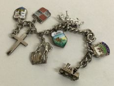 A silver and enamelled charm bracelet. Approx. 25 grams. Est. £20 - £30.