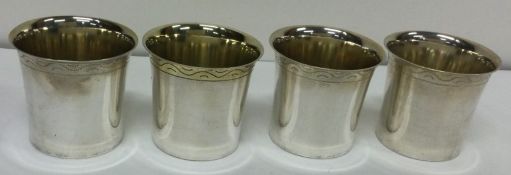 A set of four silver beakers. Approx. 85 grams. Est £100 - £150.