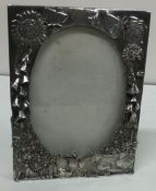 A finely chased silver plated photo frame. Est £30 - £60.