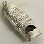 A chased silver whistle. Approx. grams. Est. £20 - £30.