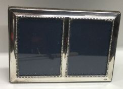 An unusual plain silver double picture frame. Shef