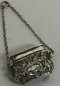 A Victorian silver vinaigrette in the form of a handbag on suspension chain. Birmingham circa 1845.