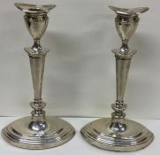 A pair of Adams' style silver candlesticks. Sheffield. Approx. 1215 grams. Est. £100 - £150.