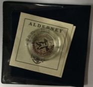 An Alderney One Pound proof 50th Anniversary End World War II coin with certificate of authenticity.