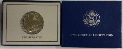 A Liberty 100th Birthday Statue of Liberty Half Dollar with certificate of authenticity.