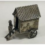 A good silver table toy in the form of a cart.