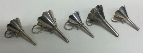 A group of five silver perfume funnels. Various dates and makers. Approx. 107 grams.