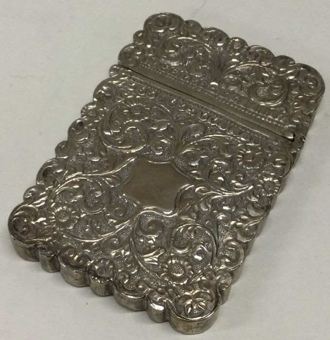 A heavy 19th Century Indian silver card case with chased decoration.