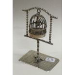 A large novelty silver bird cage on stand.