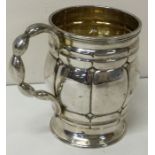 A heavy Victorian silver christening mug with unusual handle. London 1863.