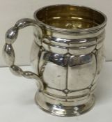 A heavy Victorian silver christening mug with unusual handle. London 1863.