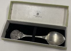A heavy cased commemorative silver spoon embossed with a castle. London 1950.