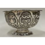 A chased Victorian bowl decorated with vines and a lions head. Sheffield 1857. By Henry Wilkinson.