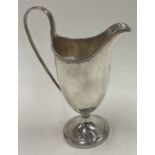A George III silver crested jug with beaded border. London 1780.