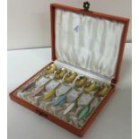A cased set of six Danish silver gilt and enamel spoons.
