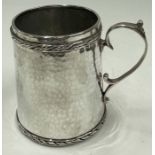 SIBYL DUNLOP: A rare silver hammered mug with embossed border. London 1920.