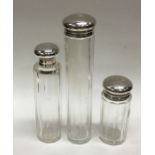 A set of three plain silver dressing table jars.