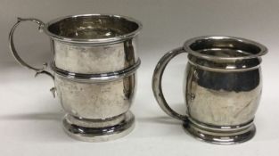 An Edwardian silver christening mug together with one other. Approx. 79 grams.