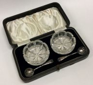A pair of silver mounted cut glass salts contained within a fitted box. Est. £20 - £30.