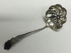 An attractive silver sifter spoon with floral decoration. Birmingham. Approx. 11 grams.