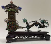 A large Chinese silver and enamelled dragon carriage.