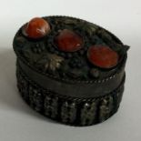 A Continental silver jewellery box mounted with stones. Approx. 27 grams.