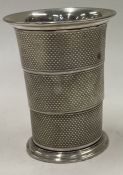 An engine turned collapsible silver beaker. Maker's mark only to base. Approx. 79 grams.