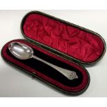 A cased silver child's spoon. London 1906 by JW&FCW.