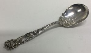 A heavy chased silver spoon with flower decoration. Marked Sterling.