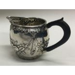 A good chased silver cream jug. London. Approx. 52 grams.