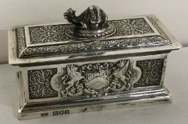 A rare Victorian silver chased silver box with coat of arms to both sides.