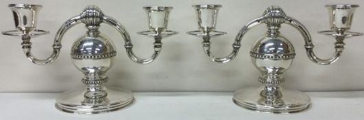 A heavy and decorative pair of silver candelabras. Birmingham 1970. By AJA.